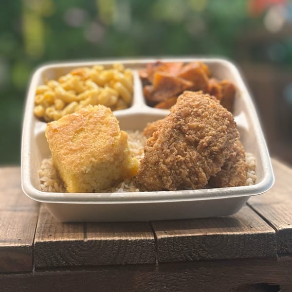 C4Eats vegan meal with fried chicken, mac and cheese, cornbread, and sweet potatoes.